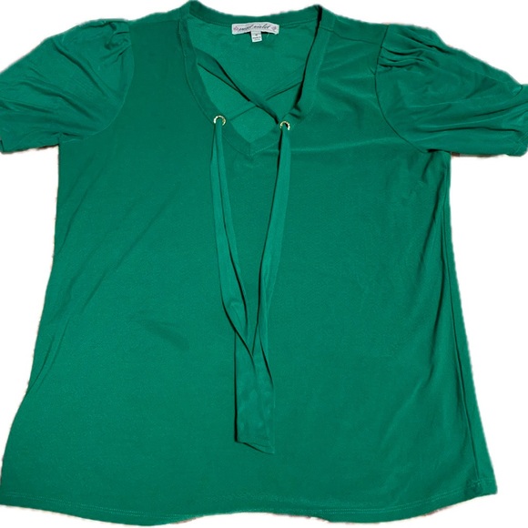 This is a green short-sleeved top with a V-neck design. - Picture 1 of 3